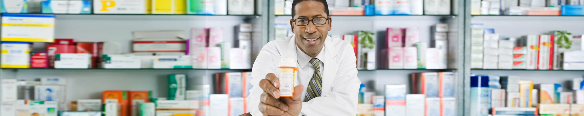 Portrait of a Male pharmacist showing pills